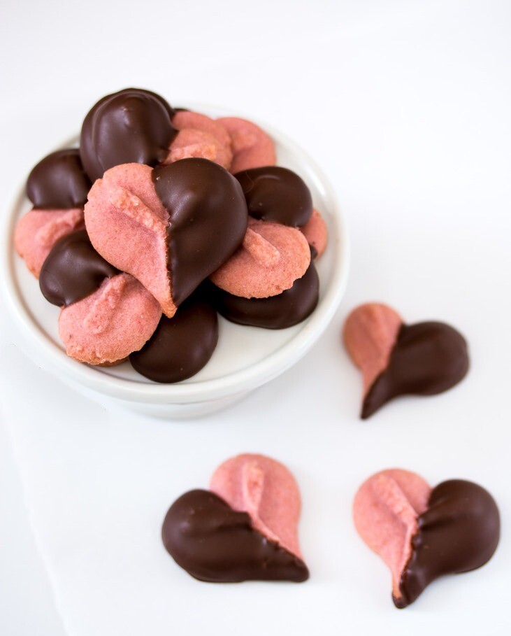 Strawberry jam gives the classic spritz cookie a kiss of natural strawberry flavor while a quick dip in rich dark chocolate makes these cookies just perfect for Valentine's Day.
