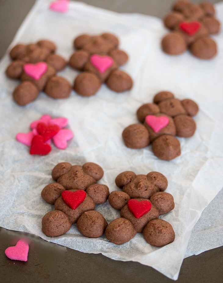 Say 'I love you' with Chocolate Raspberry Spritz Teddy Bears. A cookie press and heart-shaped sprinkles make it easy to create dozens of adorable teddy bear cookies ready to spread joy this Valentine's Day.