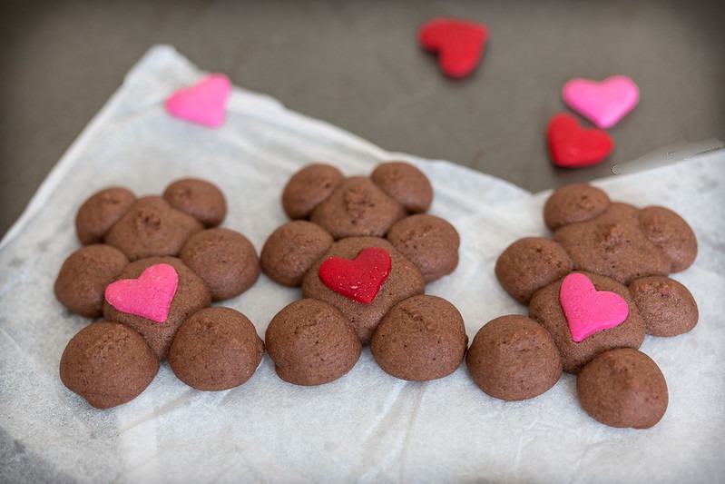 Say 'I love you' with Chocolate Raspberry Spritz Teddy Bears. A cookie press and heart-shaped sprinkles make it easy to create dozens of adorable teddy bear cookies ready to spread joy this Valentine's Day.